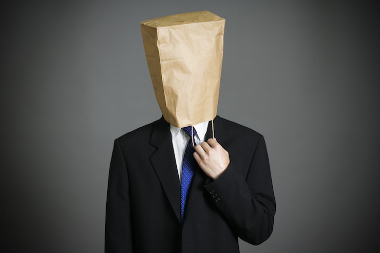 Businessman with a paper bag on head